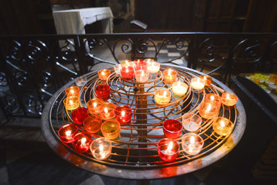 High angle view of illuminated candles on table at home