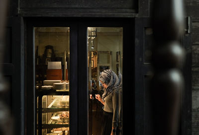 Reflection of man on glass window