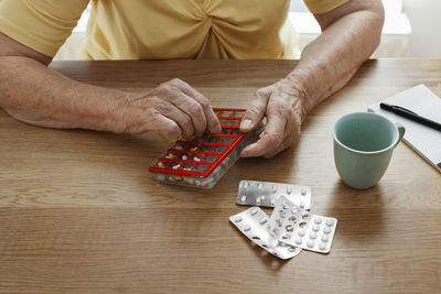 Woman's hands holding pill organizer