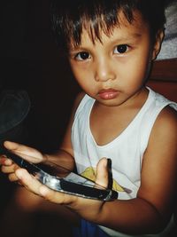 Portrait of cute girl using mobile phone at home