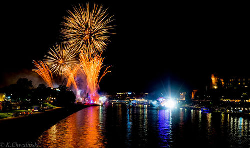 Firework display over city at night