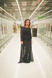 Portrait of woman standing at supermarket