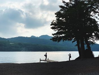 People on beach against sky