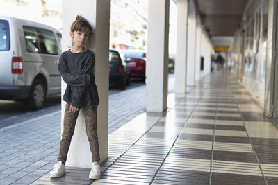 Portrait of girl standing in corridor