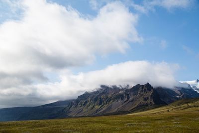 Scenic view of mountains against cloudy sky