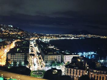 High angle view of illuminated buildings in city at night