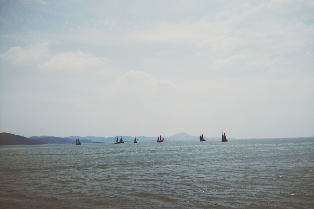 sea, water, waterfront, sky, horizon over water, tranquility, tranquil scene, scenics, nautical vessel, beauty in nature, transportation, nature, boat, cloud - sky, mode of transport, rippled, beach, idyllic, day, seascape