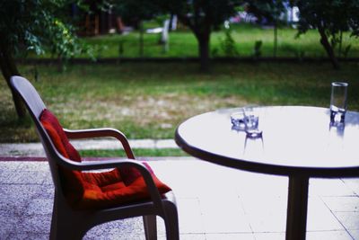 Empty chairs and table in front yard