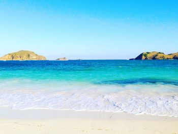 View of beach against blue sky