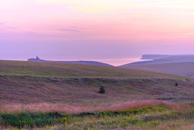 Scenic view of field against sky during sunset