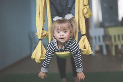 Portrait of young woman exercising in gym