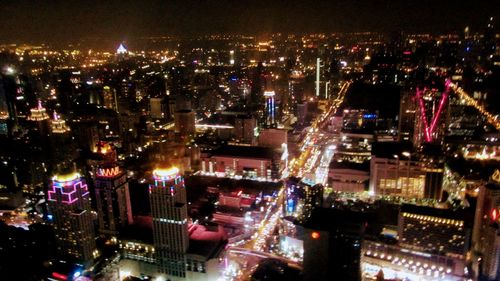 High angle view of illuminated buildings in city at night