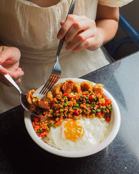 Cropped hand of person preparing food