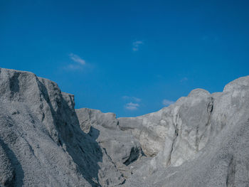 Low angle view of rock formation against sky