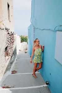Full length of young woman against sky