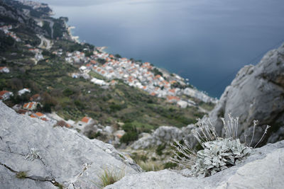 Close-up of snow on rock against sky