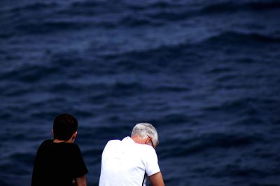 Rear view of people at beach 