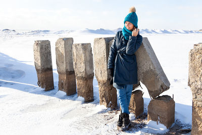 Man standing on snow covered land