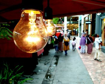 People in illuminated market at night