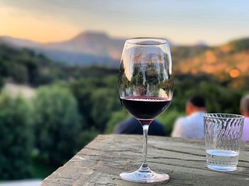 Bokeh wine glass in valley at sunset