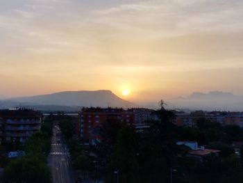 High angle view of cityscape against sky at sunset