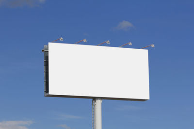Low angle view of crane against clear blue sky
