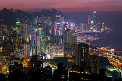 High angle view of illuminated city buildings at night