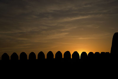 Low angle view of silhouette landscape against sky during sunset