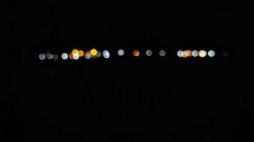 Defocused image of illuminated lights at night