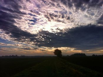 Silhouette of landscape against cloudy sky