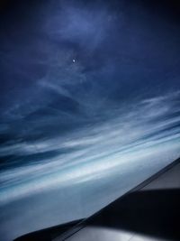 Airplane wing against sky