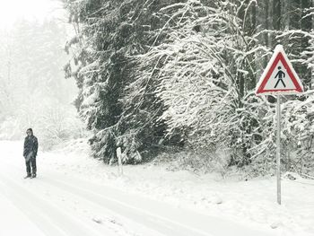 Road amidst trees during winter