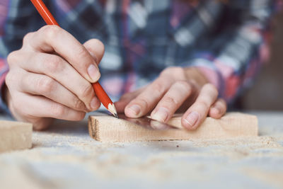 Midsection of carpenter working in workshop