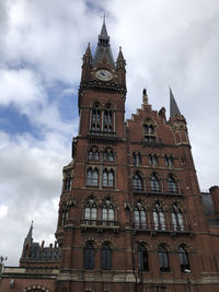 Low angle view of clock tower against sky