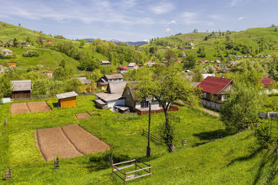 High angle view of houses on field against sky