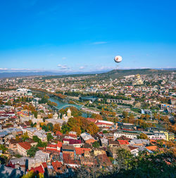 High angle view of townscape against blue sky