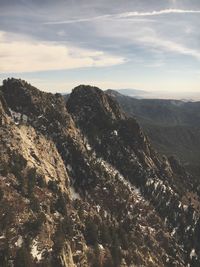 Scenic view of mountains against cloudy sky