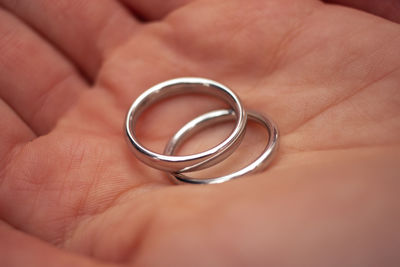 Close-up of person holding wedding rings