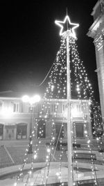 Illuminated christmas lights against sky at night