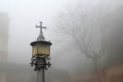 Communications tower against sky during foggy weather