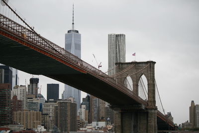 Low angle view of bridge and buildings against sky