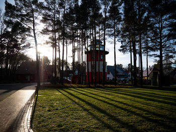 Street amidst trees and buildings against sky