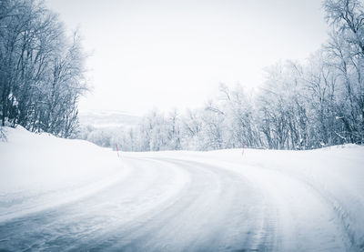 Snow covered land against sky