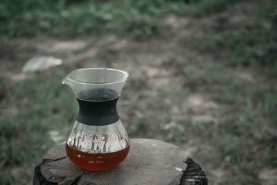 High angle view of drink on rock at field