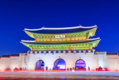 View of illuminated building against blue sky