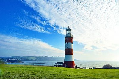 Lighthouse against cloudy sky