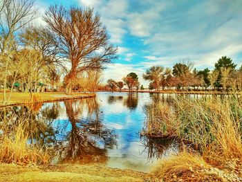 Scenic view of lake against cloudy sky