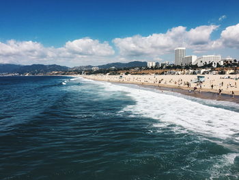 Scenic view of sea and town against sky