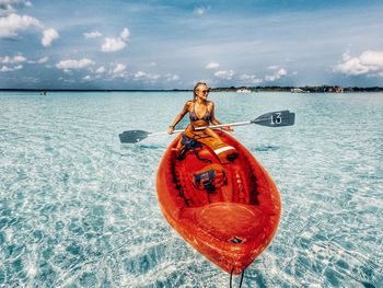 Portrait of man on boat in sea against sky