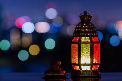 Lantern and small plate of dates fruit for the muslim feast of the holy month of ramadan kareem.